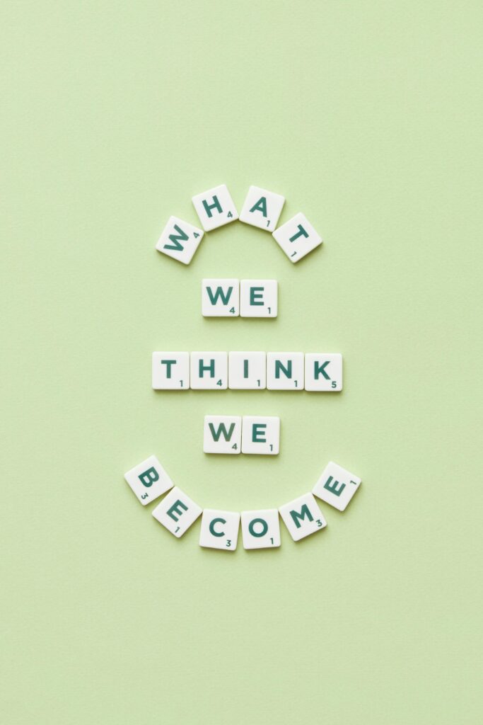 Motivational quote arranged with letter tiles on a light green background.