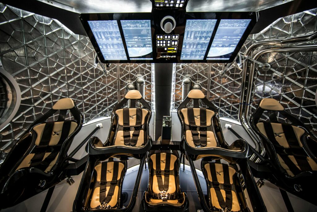 Modern spacecraft cabin showing ergonomic seats and digital control panels in a sophisticated interior.